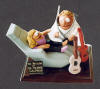 Podiatrist figurine, working on patient,cell phone,his guitars..."rock on Doc"