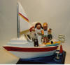 Custom made Wedding Cake Topper of couple on their yacht, he even has his bike on board, and Bride can't put down her hair dryer...oh, the price of beauty..