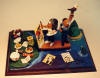 Made to order figurine of fishing pharmacist and his artistic wife, symbolic eagle at the ready, an original gift for the person who has everything!