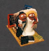 Cake topper of newleyweds on a Gold Am. Ex card