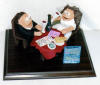 Engagement figurine, he's offering the ring at restaurant
